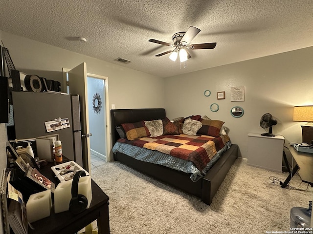 carpeted bedroom featuring ceiling fan, stainless steel fridge, and a textured ceiling