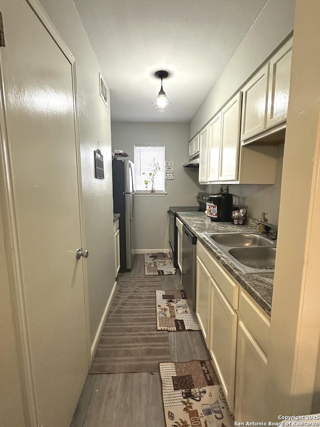 kitchen featuring sink, dark hardwood / wood-style floors, and appliances with stainless steel finishes