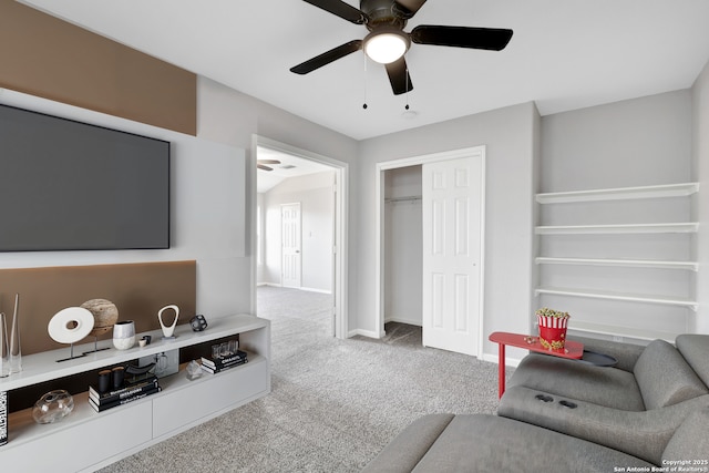 carpeted living room with ceiling fan