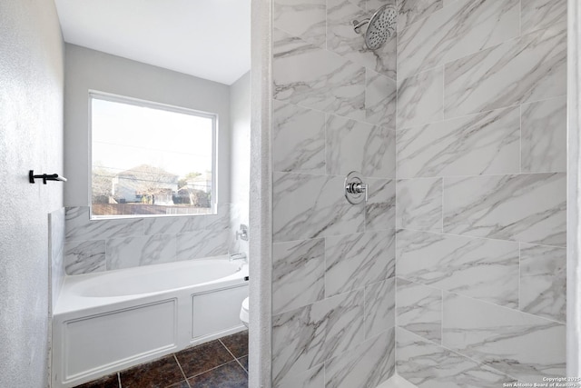 bathroom featuring toilet and tiled shower / bath