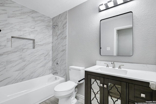 full bathroom with vanity, toilet, and tiled shower / bath