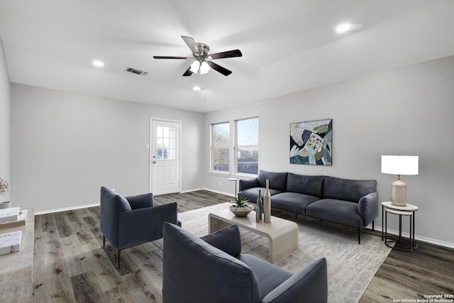 living room featuring hardwood / wood-style flooring and ceiling fan