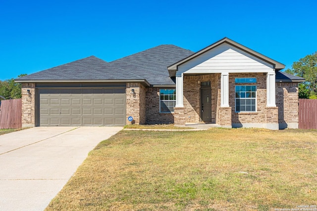 view of front of house with a front yard and a garage