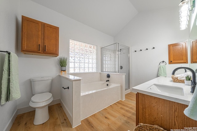 full bathroom featuring vanity, vaulted ceiling, hardwood / wood-style flooring, shower with separate bathtub, and toilet