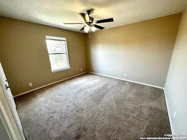 carpeted spare room featuring a textured ceiling