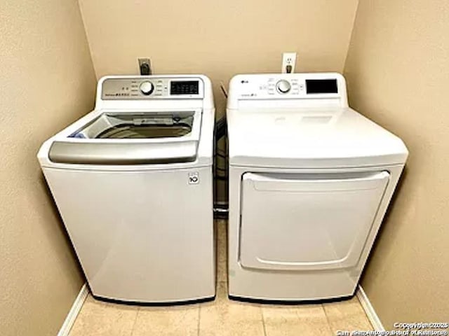 washroom with light tile patterned floors and separate washer and dryer