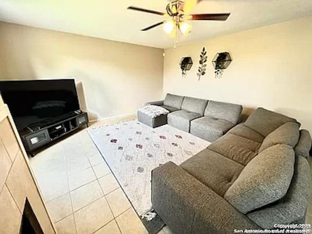 tiled living room with ceiling fan