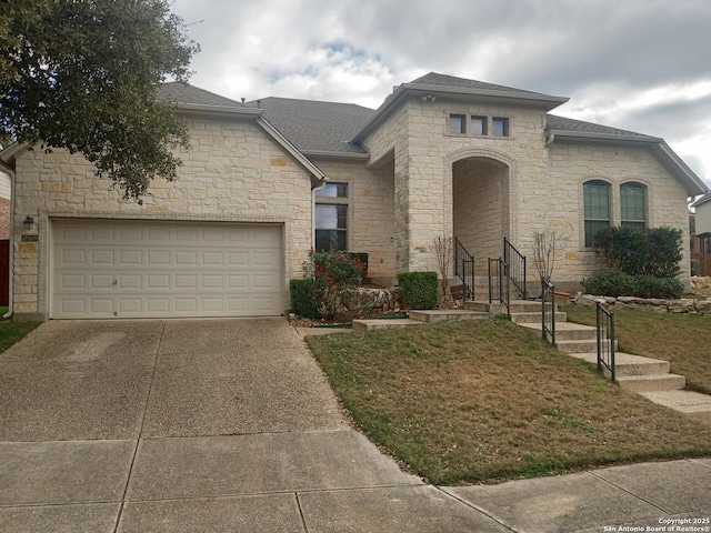 view of front facade with a garage and a front lawn