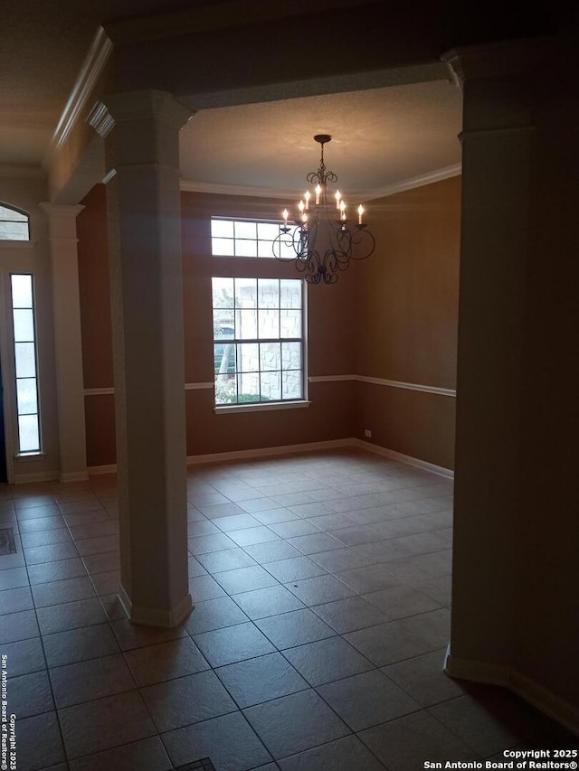 tiled empty room featuring ornate columns, ornamental molding, and a notable chandelier