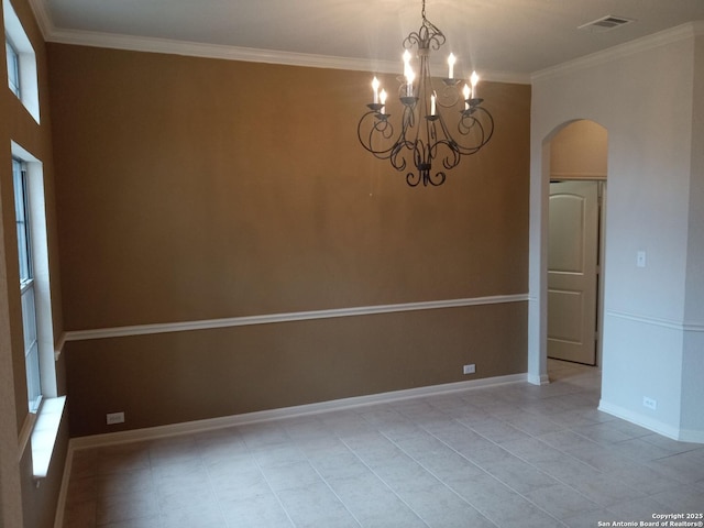 spare room with light tile patterned floors, an inviting chandelier, and crown molding