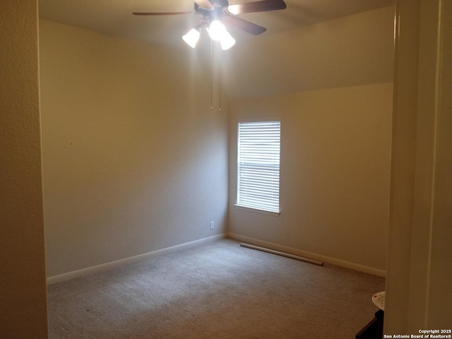 carpeted spare room featuring ceiling fan