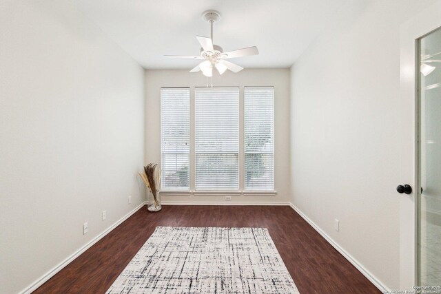 unfurnished room featuring dark hardwood / wood-style flooring and ceiling fan