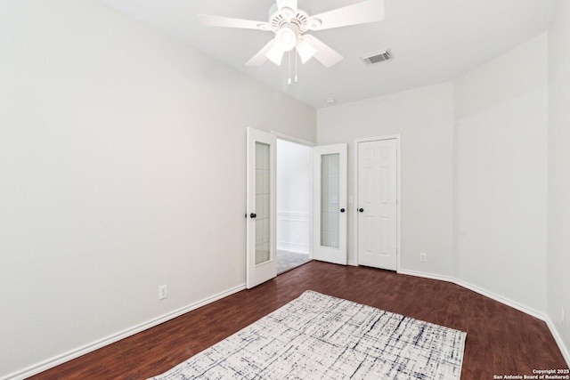 interior space featuring ceiling fan, dark wood-type flooring, and french doors