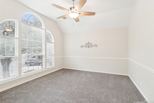 carpeted spare room featuring ceiling fan and lofted ceiling