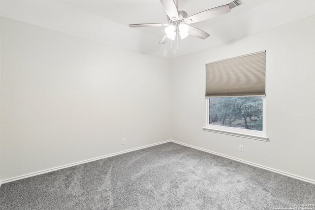 carpeted spare room with ceiling fan