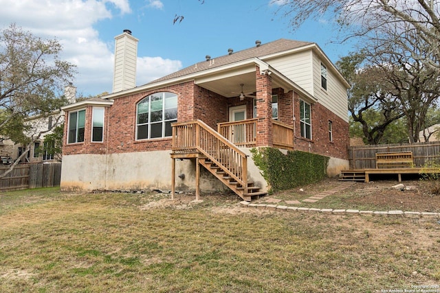 back of house featuring ceiling fan, a yard, and a deck