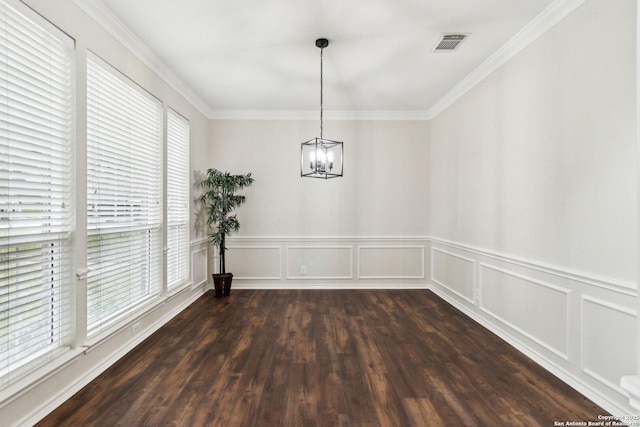 unfurnished dining area featuring a chandelier, dark hardwood / wood-style floors, and ornamental molding