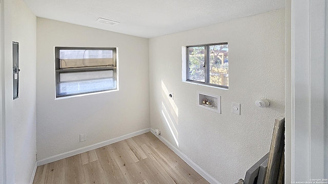 laundry area with hookup for an electric dryer, light hardwood / wood-style floors, gas dryer hookup, and hookup for a washing machine