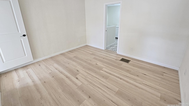 unfurnished room with light hardwood / wood-style floors