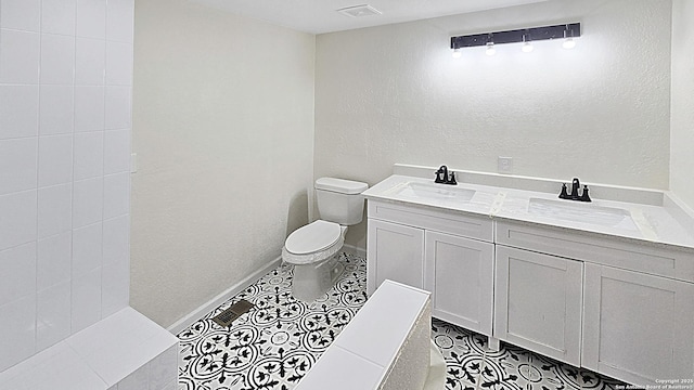 bathroom featuring tile patterned flooring, vanity, and toilet