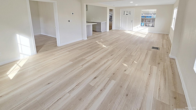 unfurnished living room with light hardwood / wood-style floors