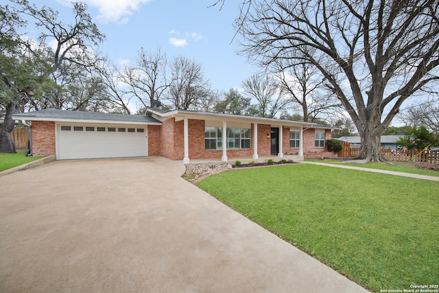 single story home featuring concrete driveway, a front lawn, brick siding, a garage, and fence