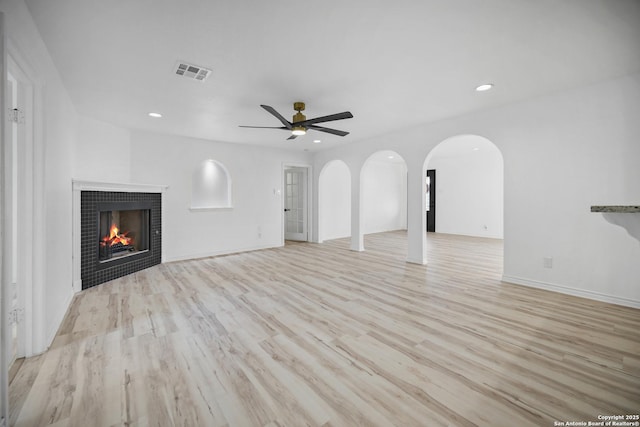 unfurnished living room with ceiling fan and light wood-type flooring