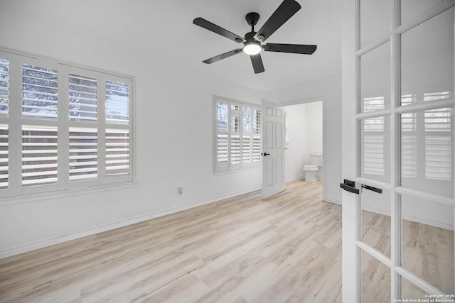 spare room with light wood-type flooring and ceiling fan