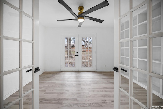 spare room featuring french doors, light hardwood / wood-style floors, and ceiling fan