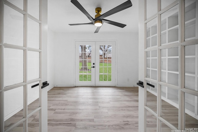 spare room with ceiling fan and french doors