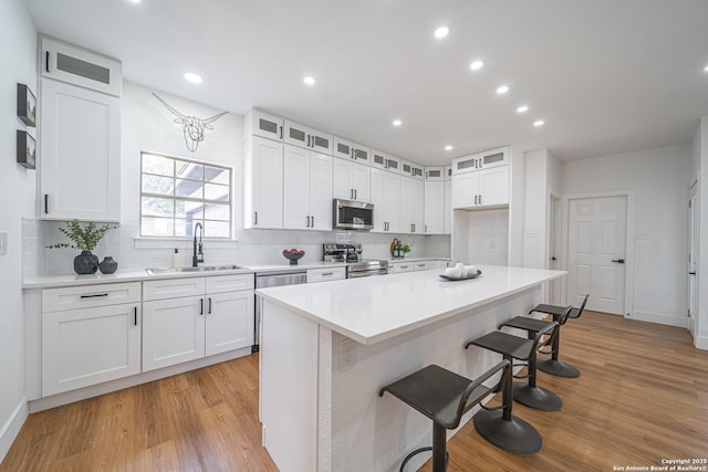 kitchen with white cabinetry, a center island, and stainless steel appliances