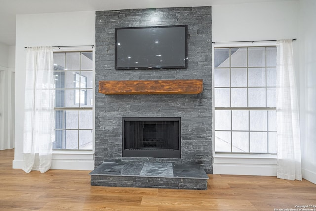 interior details featuring a fireplace and hardwood / wood-style flooring