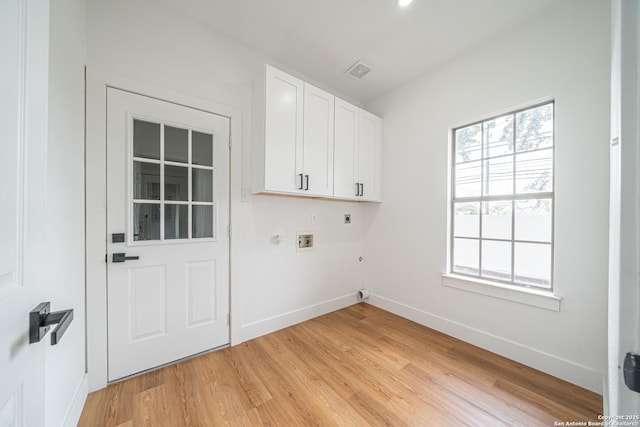 laundry room with electric dryer hookup, cabinets, gas dryer hookup, hookup for a washing machine, and light hardwood / wood-style floors