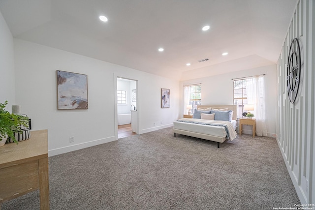 bedroom featuring ensuite bathroom and carpet floors