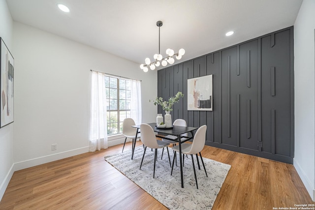 dining space with a chandelier and light wood-type flooring