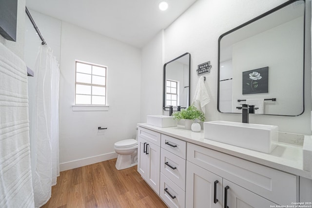 bathroom featuring hardwood / wood-style flooring, vanity, and toilet