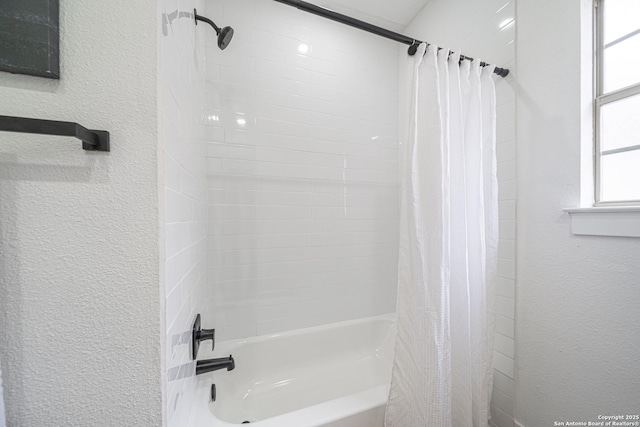 bathroom with shower / bathtub combination with curtain