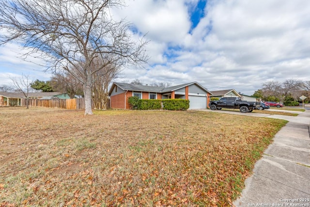 view of front of home featuring a front lawn and a garage