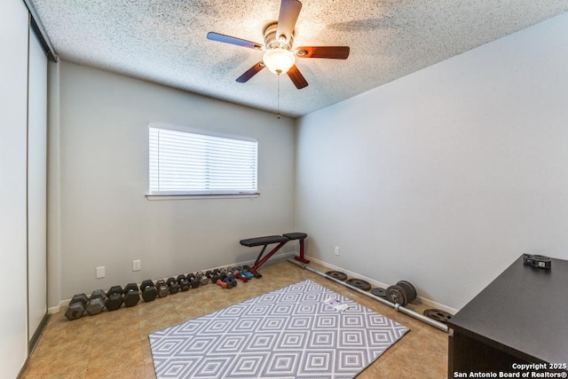 exercise room featuring a textured ceiling and ceiling fan