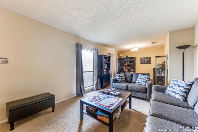 carpeted living room featuring a textured ceiling