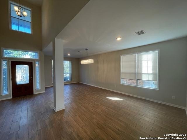 foyer featuring a notable chandelier, dark hardwood / wood-style floors, and a wealth of natural light