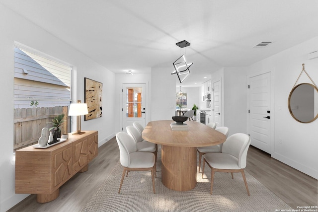 dining space with wood-type flooring