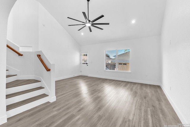 unfurnished living room featuring ceiling fan, light hardwood / wood-style floors, and lofted ceiling