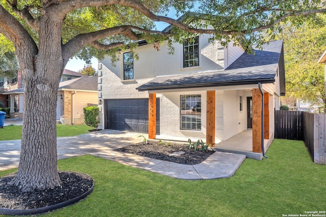 view of front of property featuring a garage and a front lawn