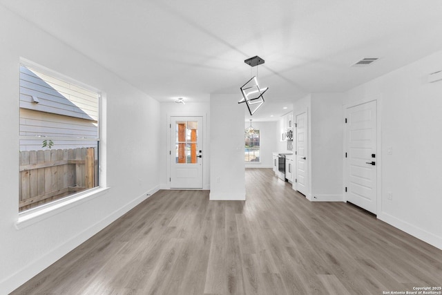 unfurnished living room featuring light hardwood / wood-style flooring