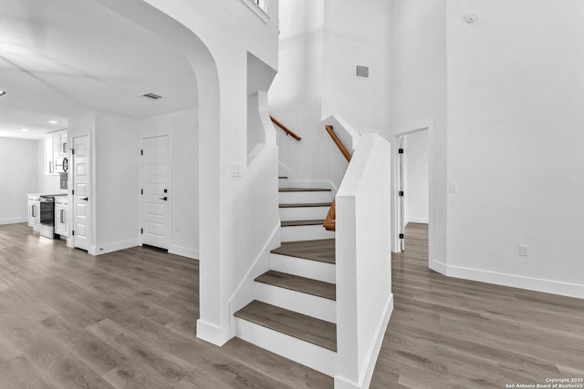 staircase with hardwood / wood-style flooring