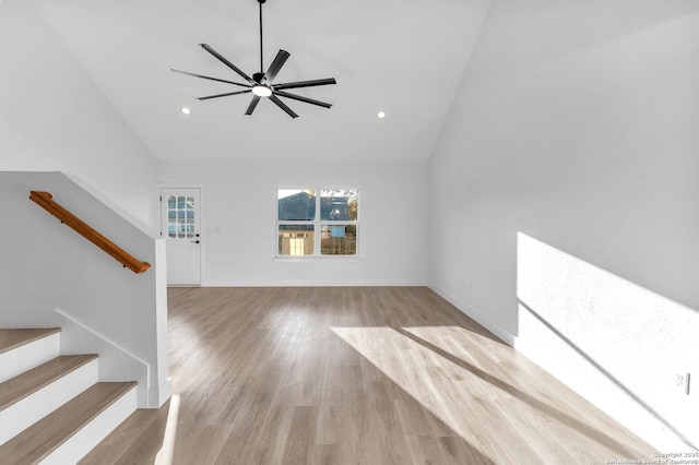 unfurnished living room with ceiling fan, light hardwood / wood-style floors, and lofted ceiling