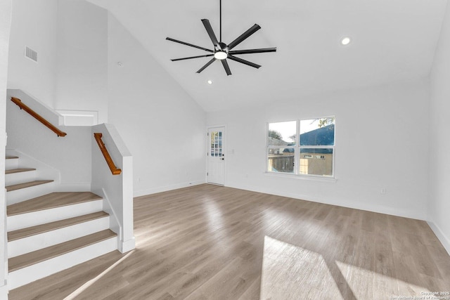 unfurnished living room with ceiling fan, high vaulted ceiling, and light hardwood / wood-style floors