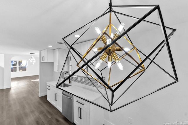 interior details featuring dishwasher, hardwood / wood-style floors, and sink