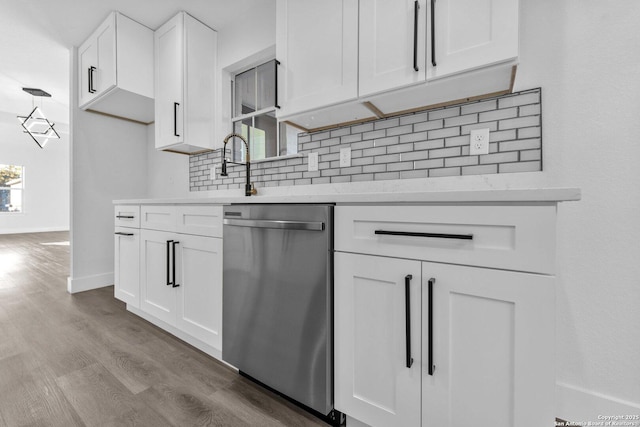 kitchen featuring dishwasher, backsplash, light hardwood / wood-style floors, and white cabinetry